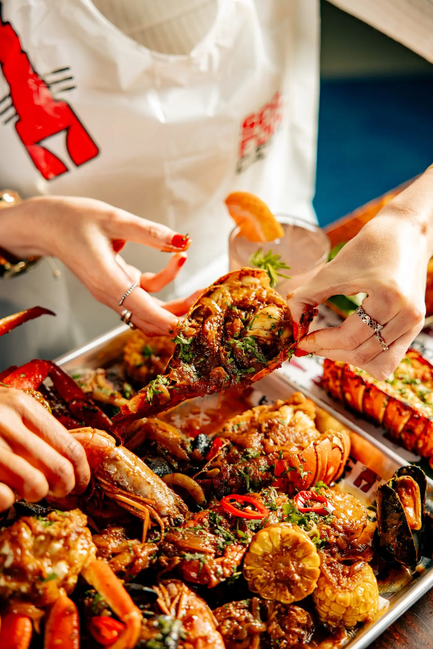 A lobster and cocktail at Seafood City Birmingham, home of Find Larry The Lobster, the free online game with a £500 prize draw